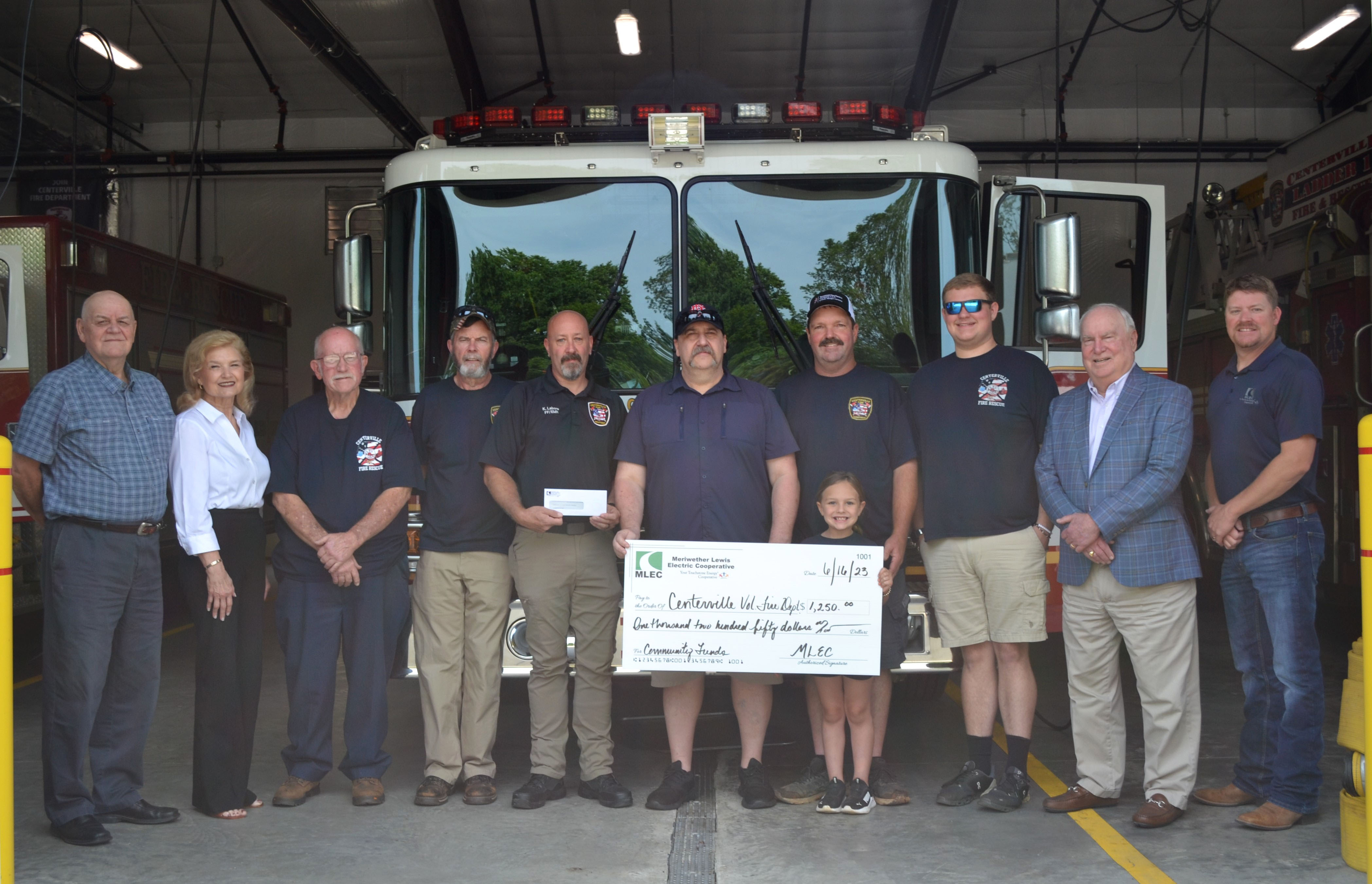 Pictured from left to right: MLEC Directors Wayne Qualls and Johnnie Ruth Elrod; Centerville Firefighters Charles Horner, Marvin Dorton, Kyle Labore, Jason Dotson, Centerville Fire Captain Greg Johnston and granddaughter Tinslee, and Firefighter McKale Baltz; MLEC Director Dr. Zack Hutchens, and District Manager Matthew Chessor.