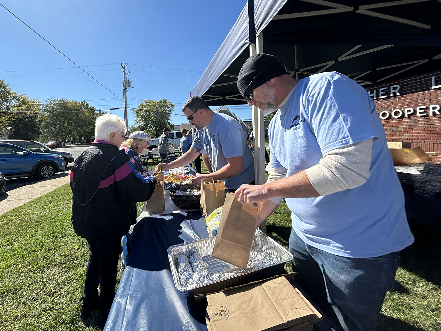 MLEC employees pictured from left to right: Lewis County Meter Technician Gates Roberson and Journey Lineworker Troy Walton greeting members and handing out free lunches.